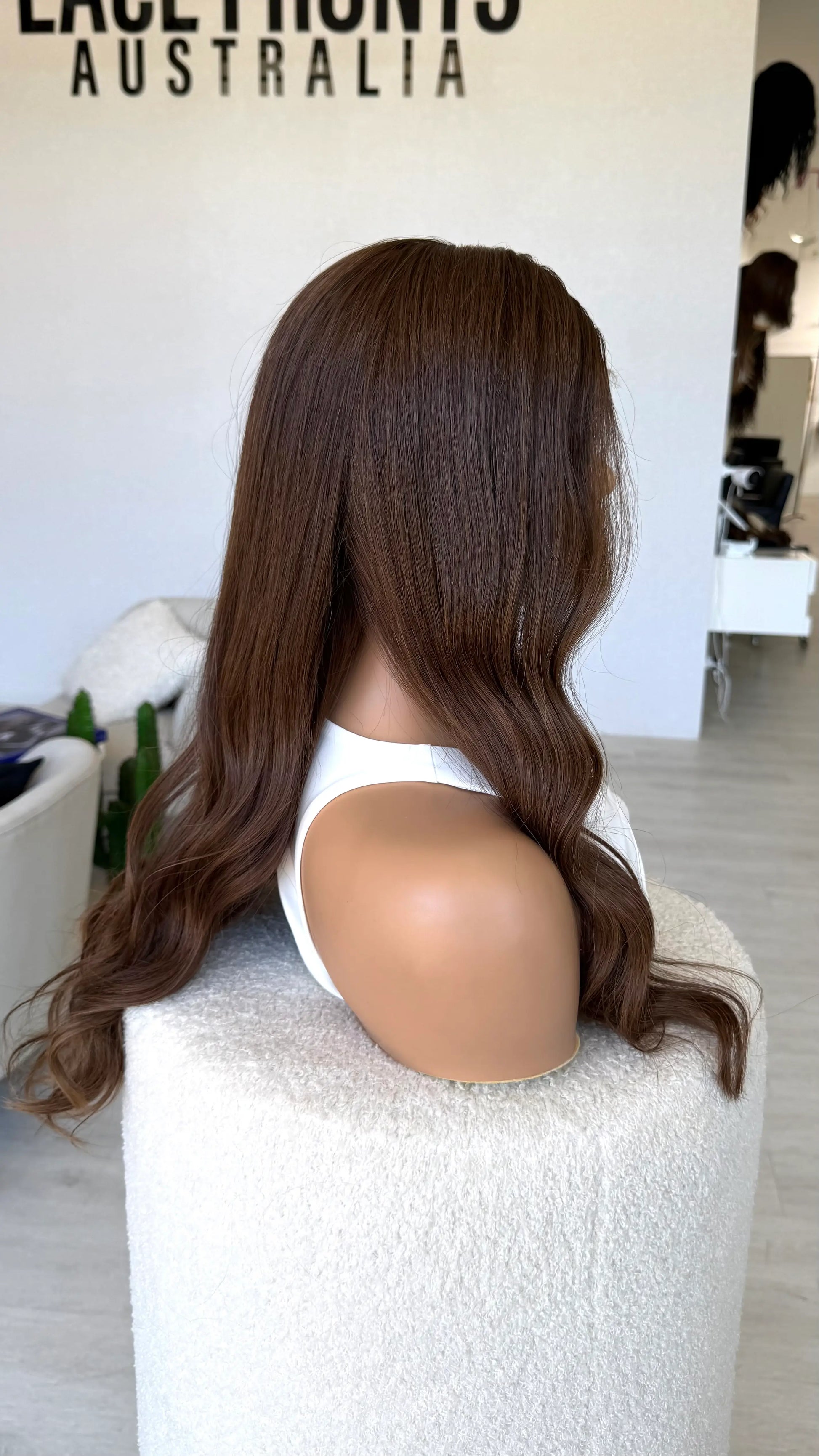 dark brunette warm toned, side on view, 24 inches, wavy hair. medical lace front wig.