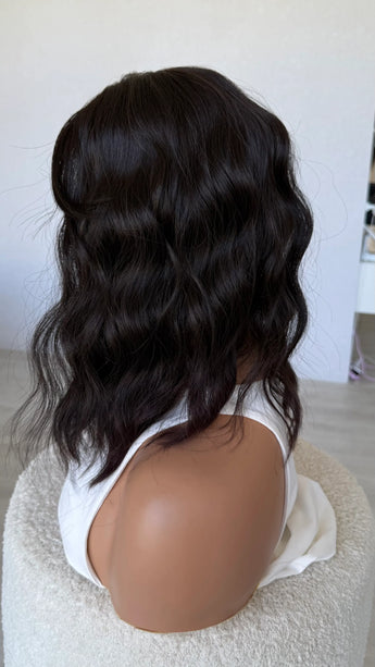 wavy hair synthetic side on view, dark brunette.