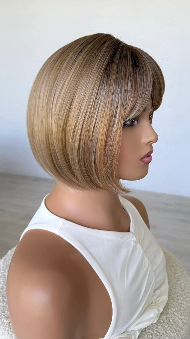 honey topper side on view, darker root mixed tone blonde warm toned.