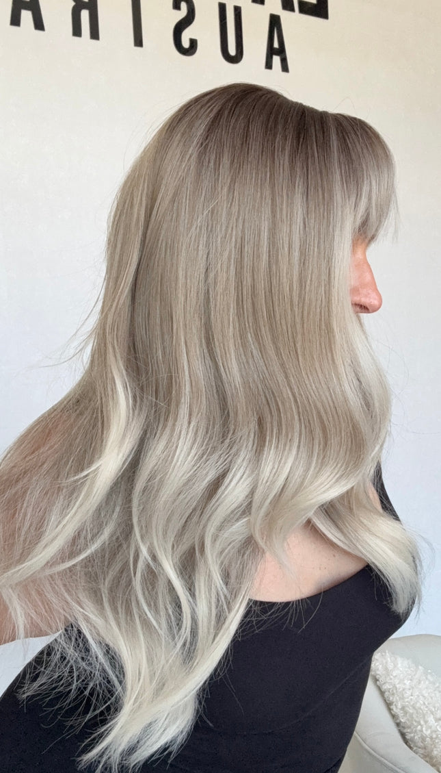 silver ombre synthetic topper with fringe and light wave. middle parting darker root, heat safe topper.