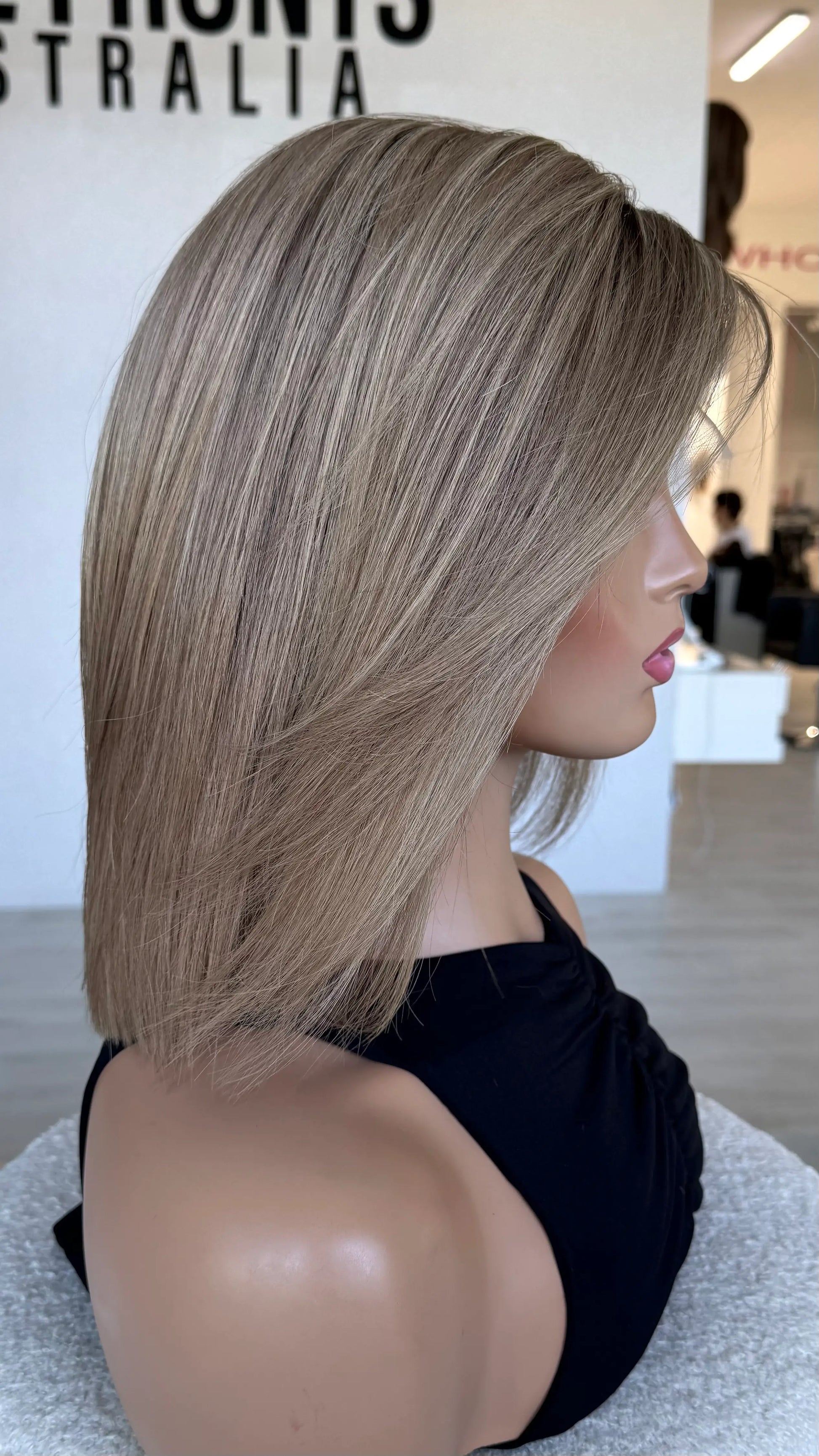 side view showing soft blend of blonde tones, cut to 14 inch with light face layering.