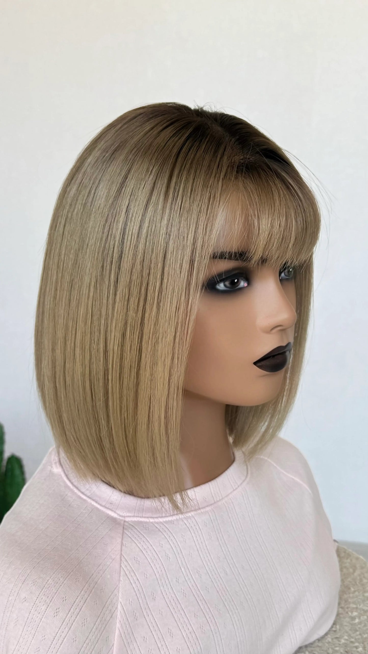 sale human hair lace front wig, fringe cut with middle parting, dark ombre blonde colouring throughout.