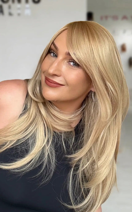 a golden blonde layered hair wig with a warm golden blonde root to lilghter gold blonde ends, layers throughout for movement.