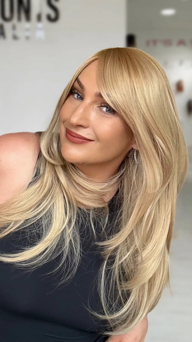 a golden blonde layered hair wig with a warm golden blonde root to lilghter gold blonde ends, layers throughout for movement.