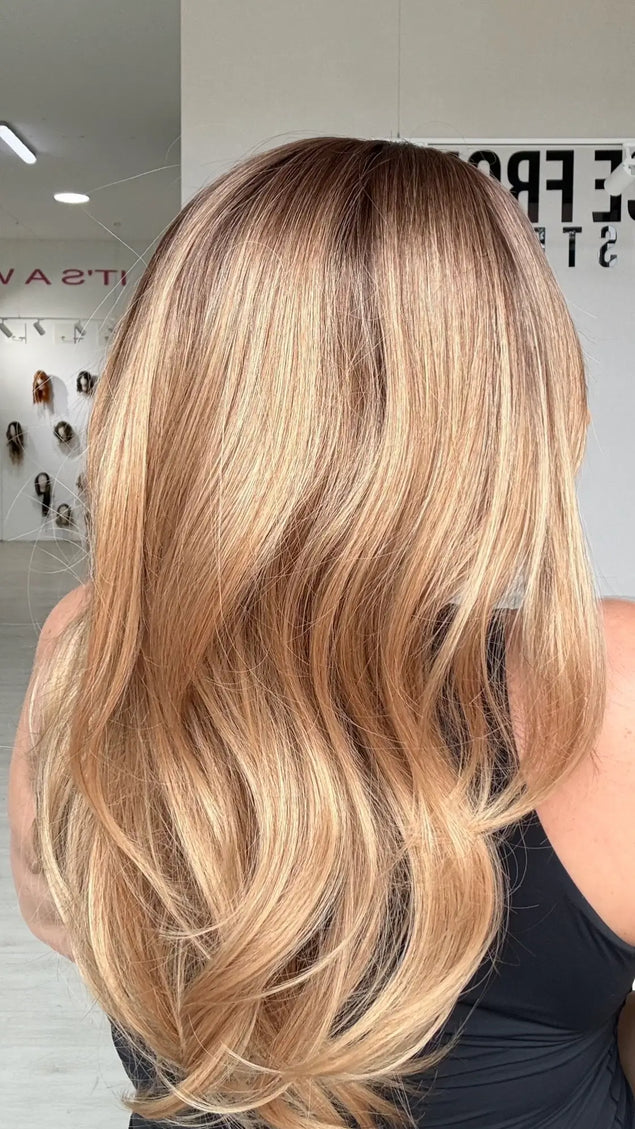 a side view of the golden blonde ombre ends, with the brunette shadow root for dimension and to create a natural look.