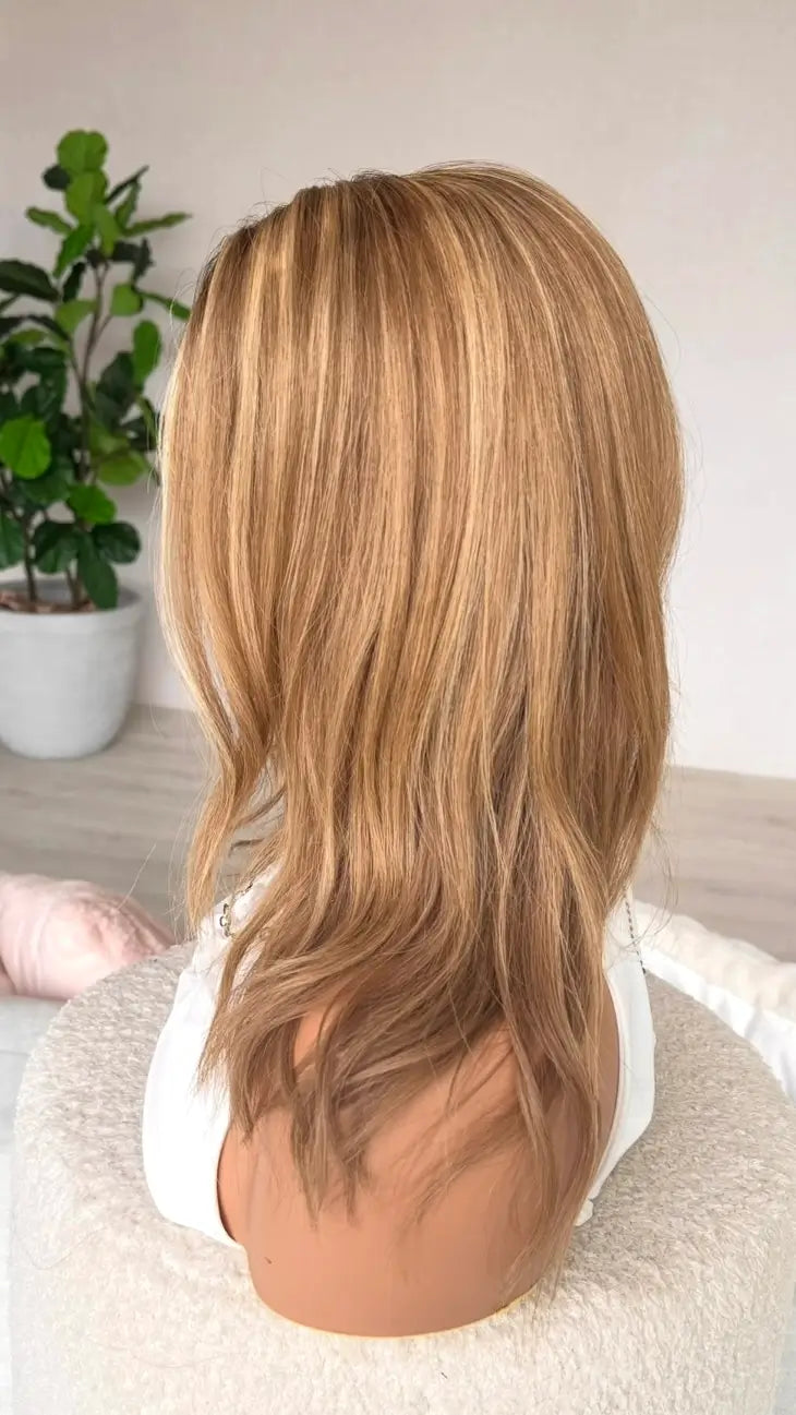 side on view golden blonde with highlights and lowlights, golden blonde hair.