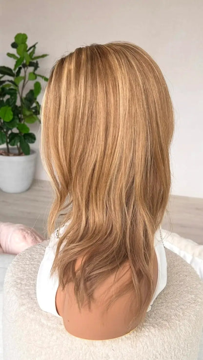 side on view golden blonde with highlights and lowlights, golden blonde hair.