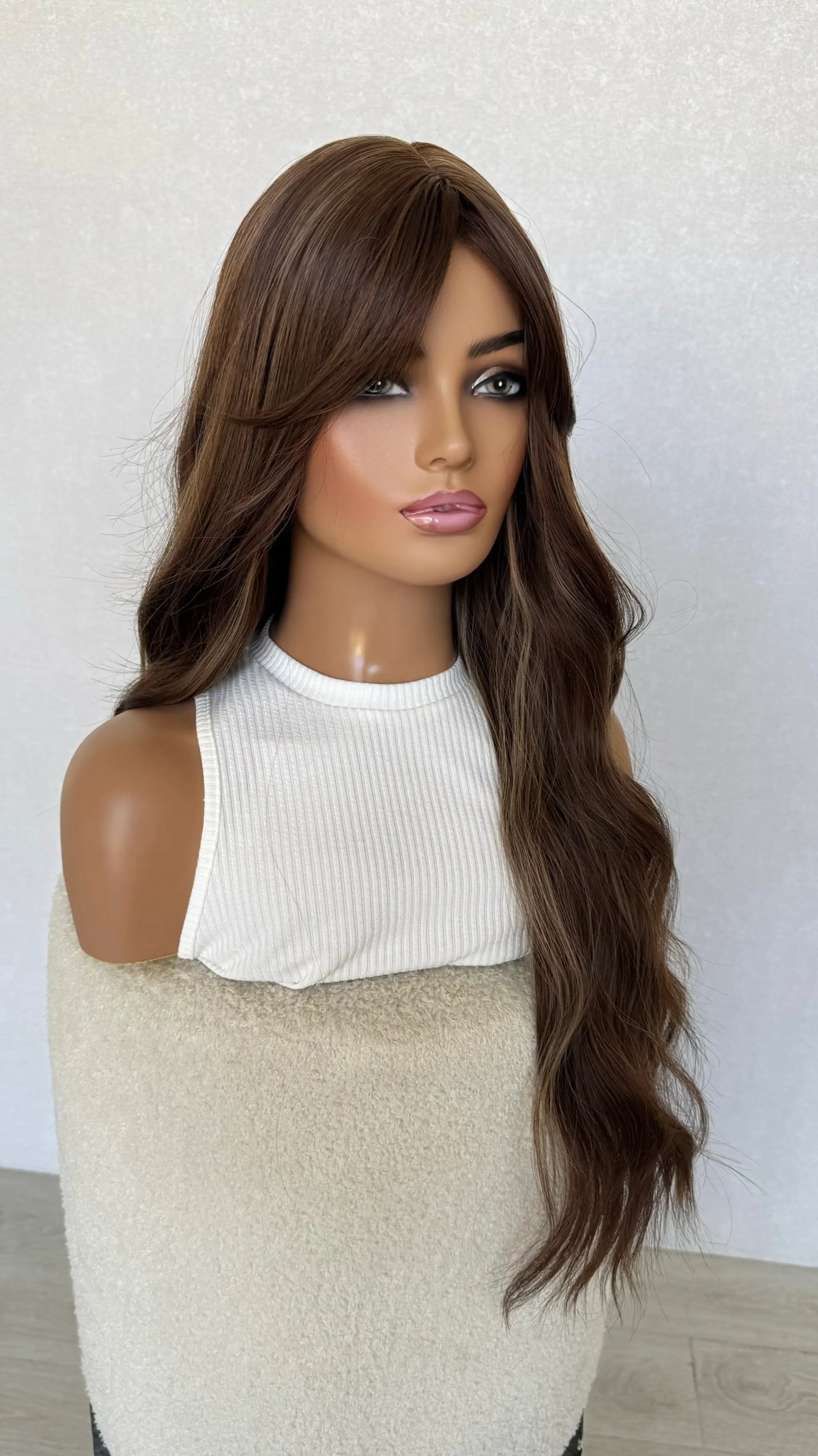 synthetic long fringe wig fringe parted to the side.