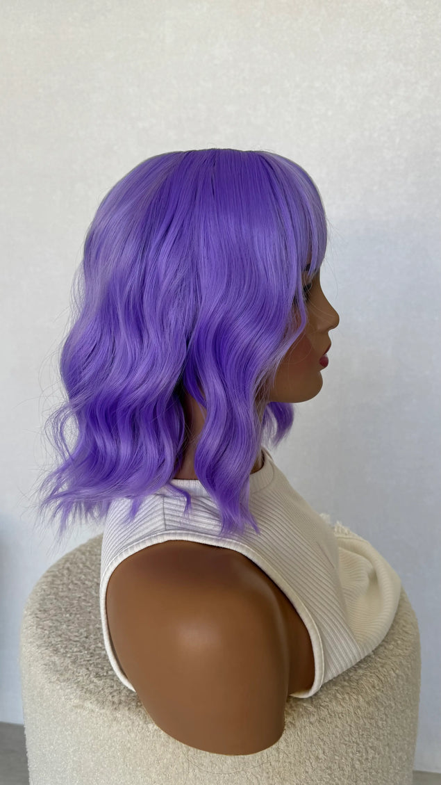 wavy purple hair wig, side on view, middle part, fringe synthetic wig.