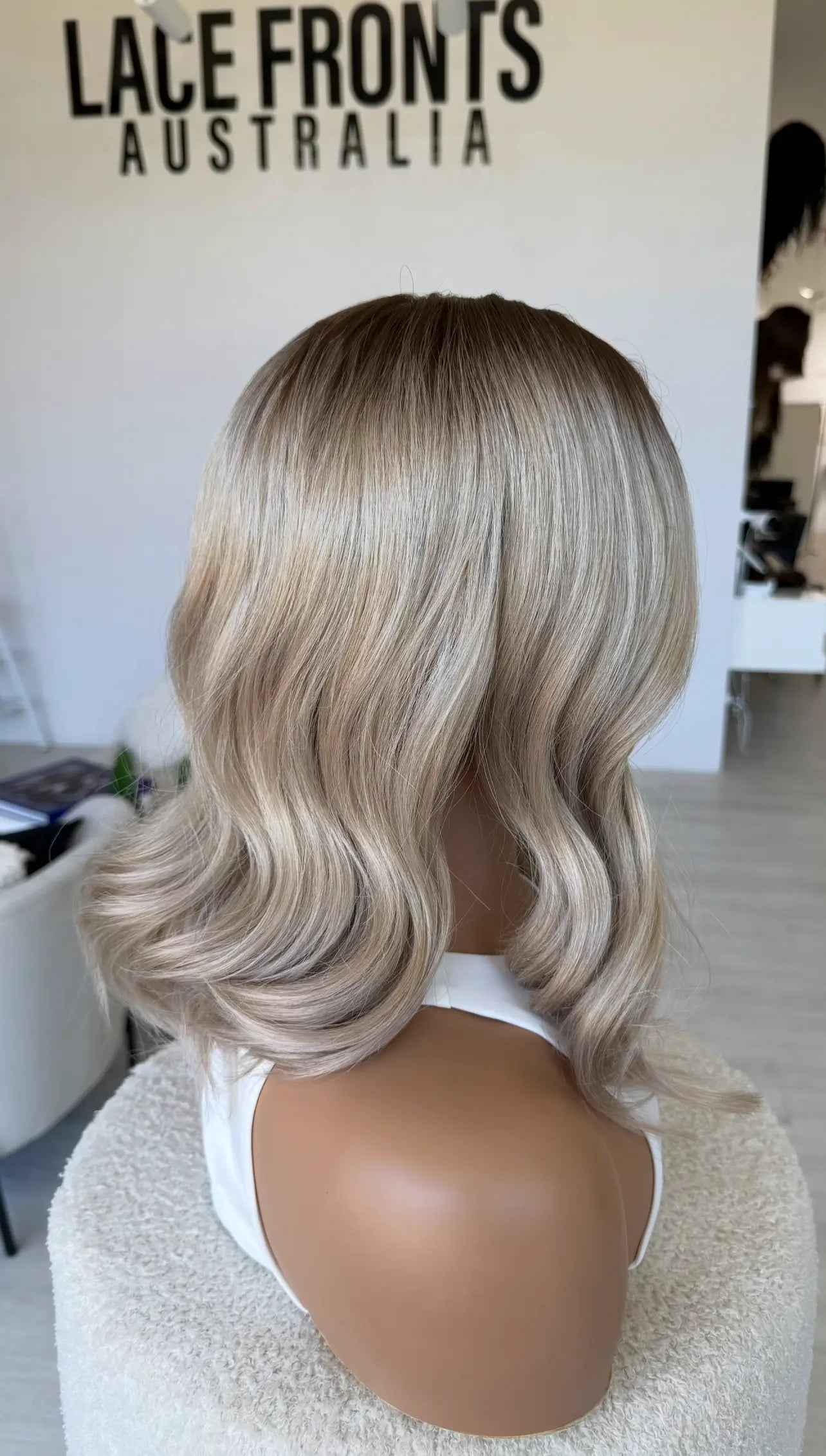 side on view blonde syntheitc hair, heat safe, glueless lace front wig, t-part lace, middle part, wavy hair synthetic australia.