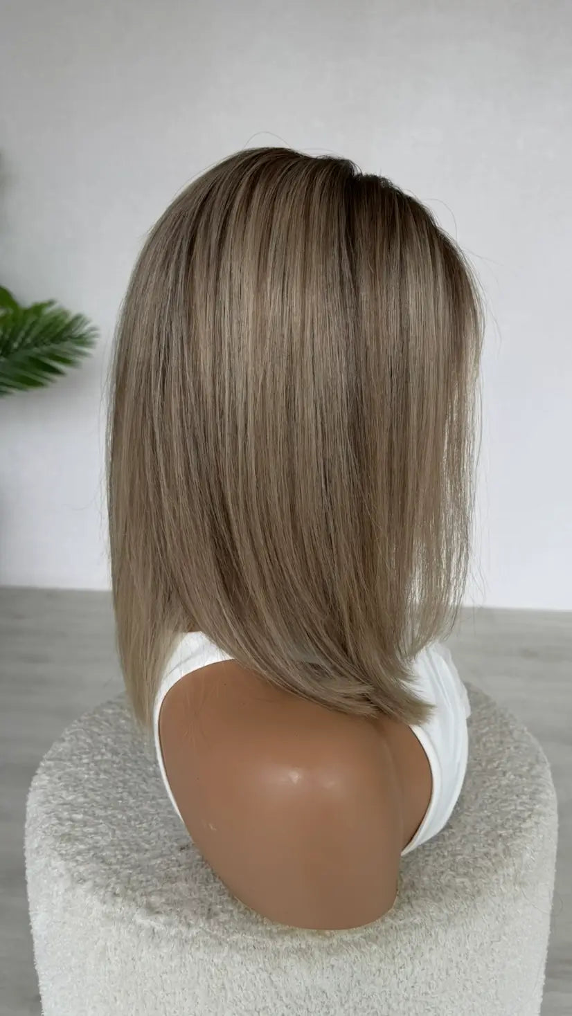 brazilian remy hair wig from the side on view, dark root with lowlights throughout.