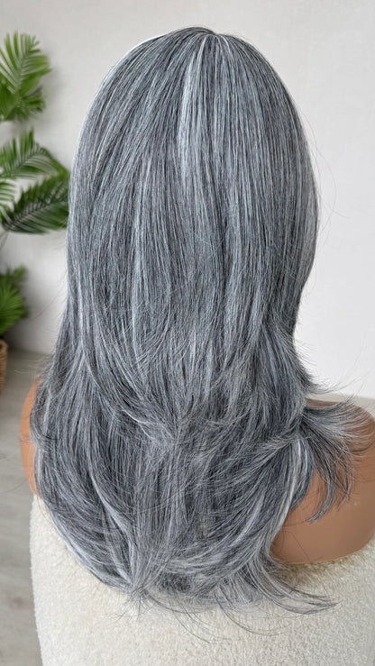 grey view back view, salt and pepper coloured hair with layers and curtain bangs