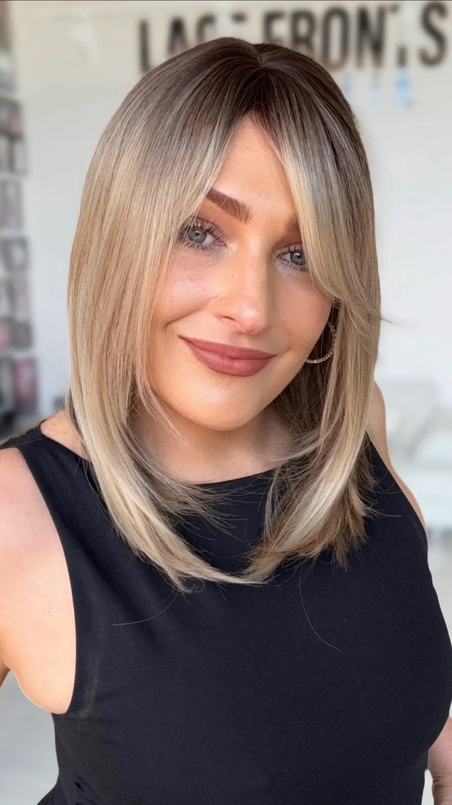 slight side part, with face framing layers for shaping around face, middle to slight side part, long bob length.