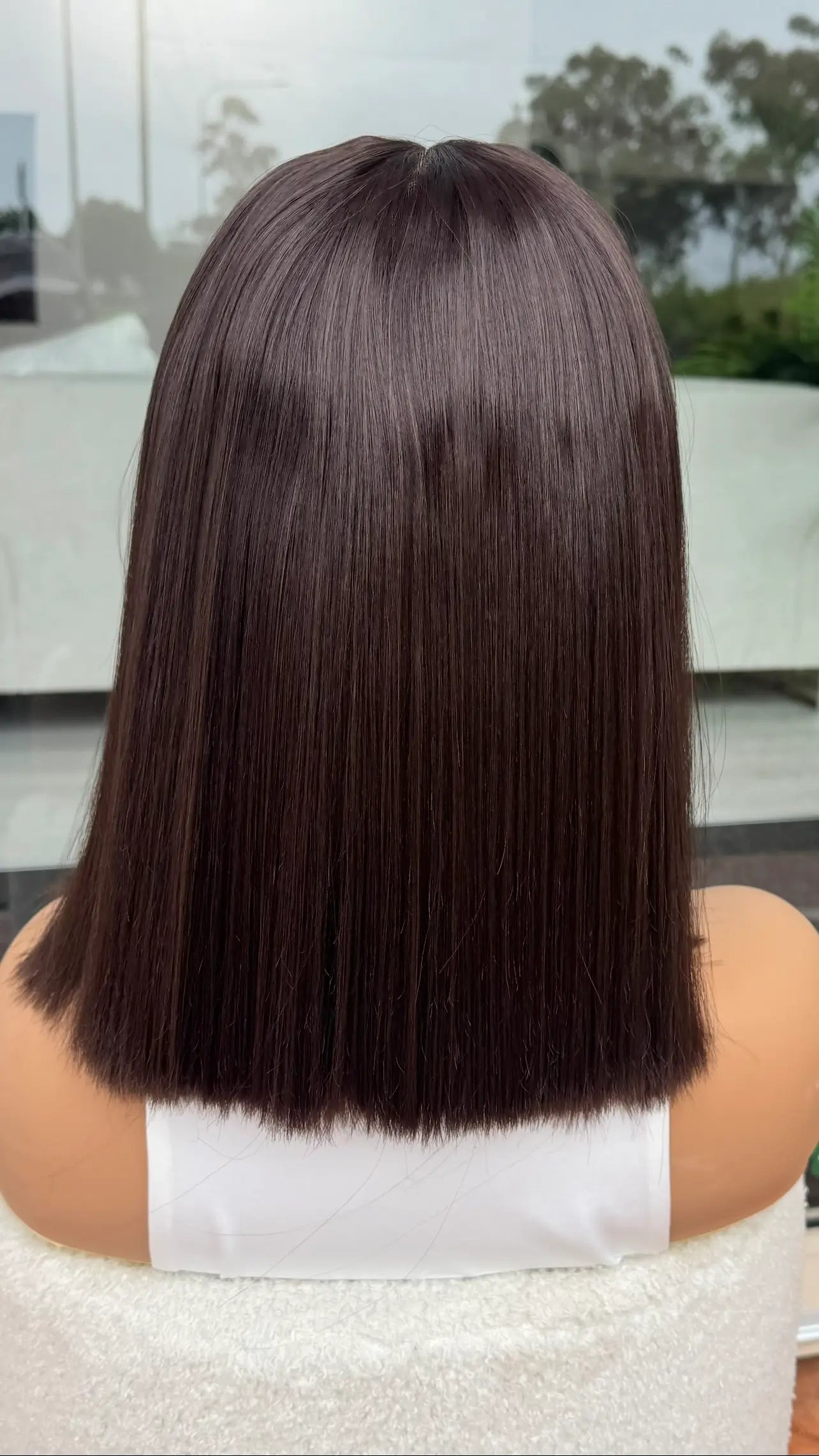 back view showcasing straight dark brown hair. lacefront synthetic - heat safe. 