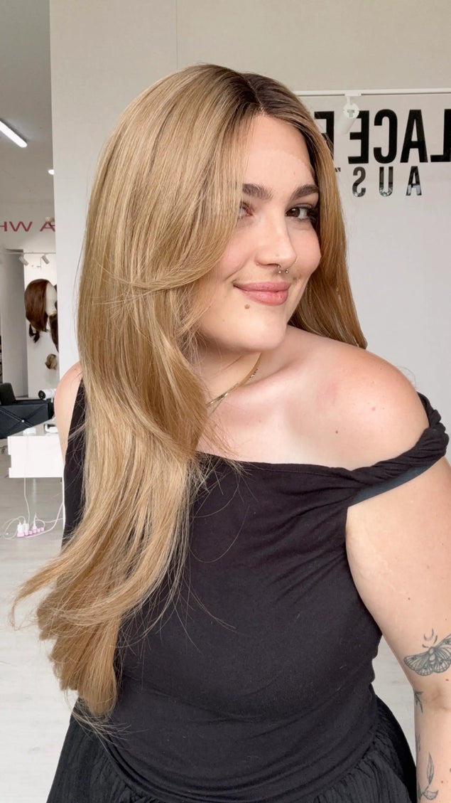 t-part lace front wig with a set middle part and glueless wig cap. long length layered honey blonde hair with shadow root and heat safe hair.