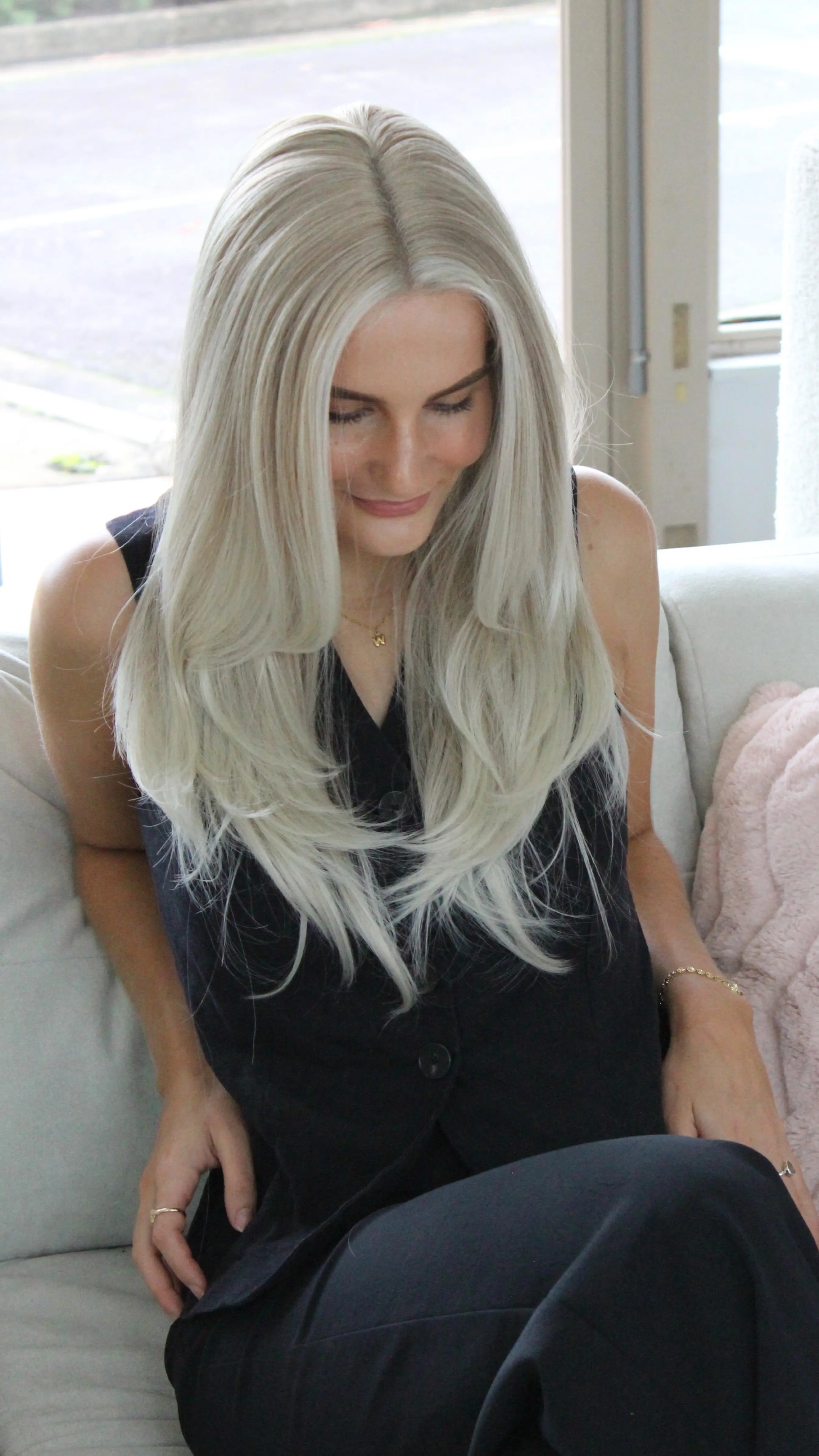 layered blonde wig from top view showing natural hairline and colour.