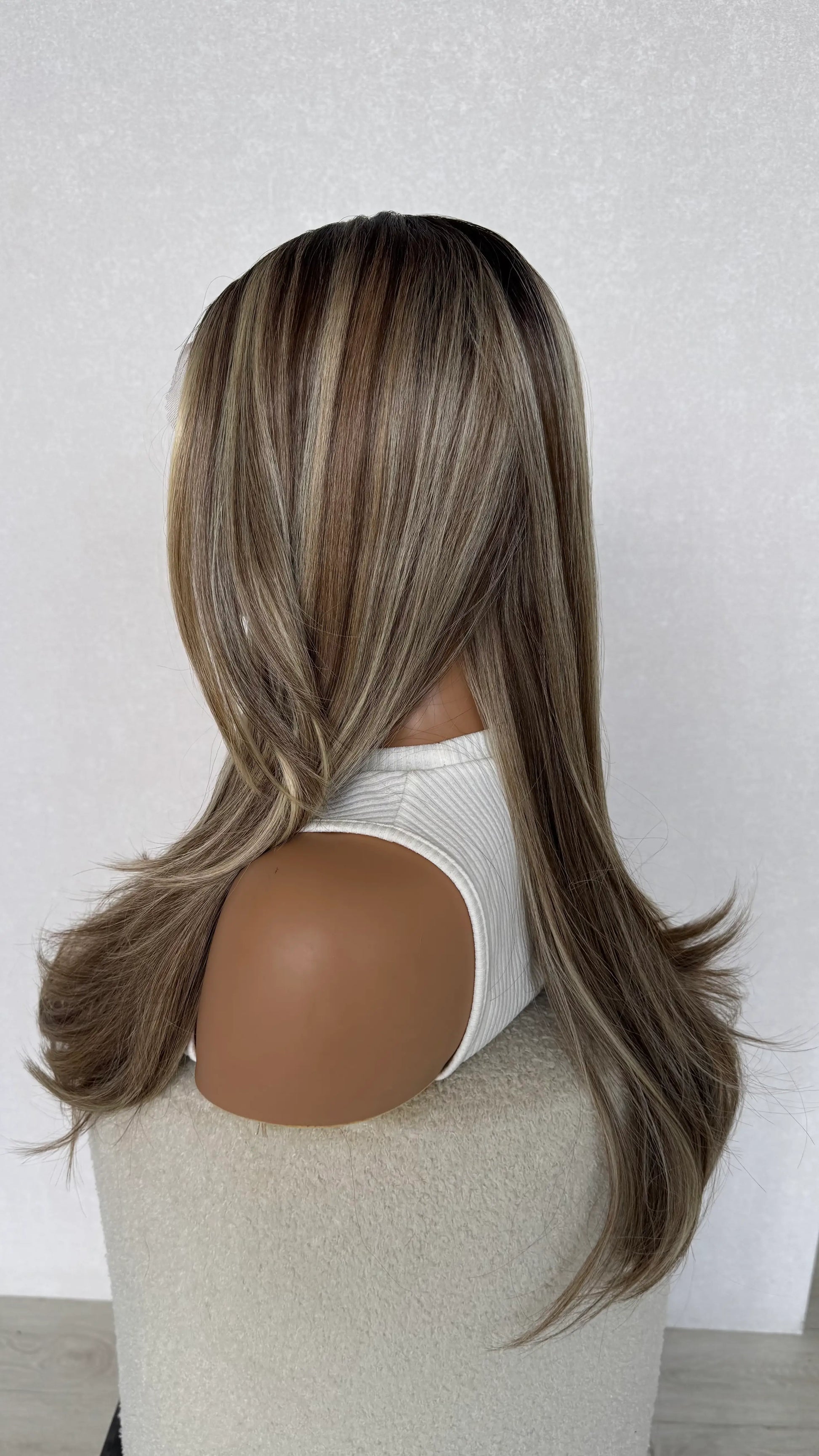 toasted marshmallow synthetic side on view, curtain bang long layers.