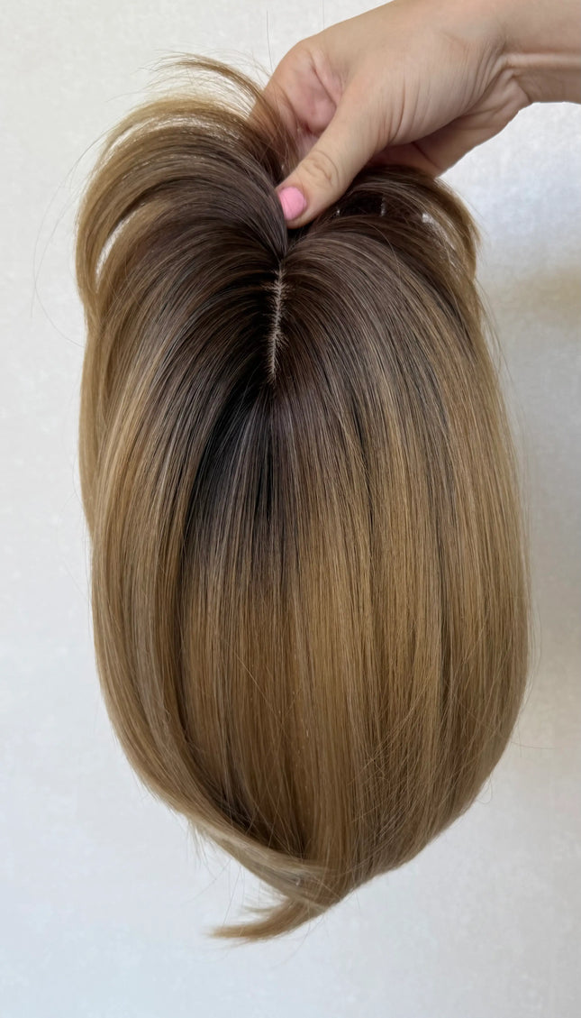 synthetic topper top view, showing hairline and part, dark root