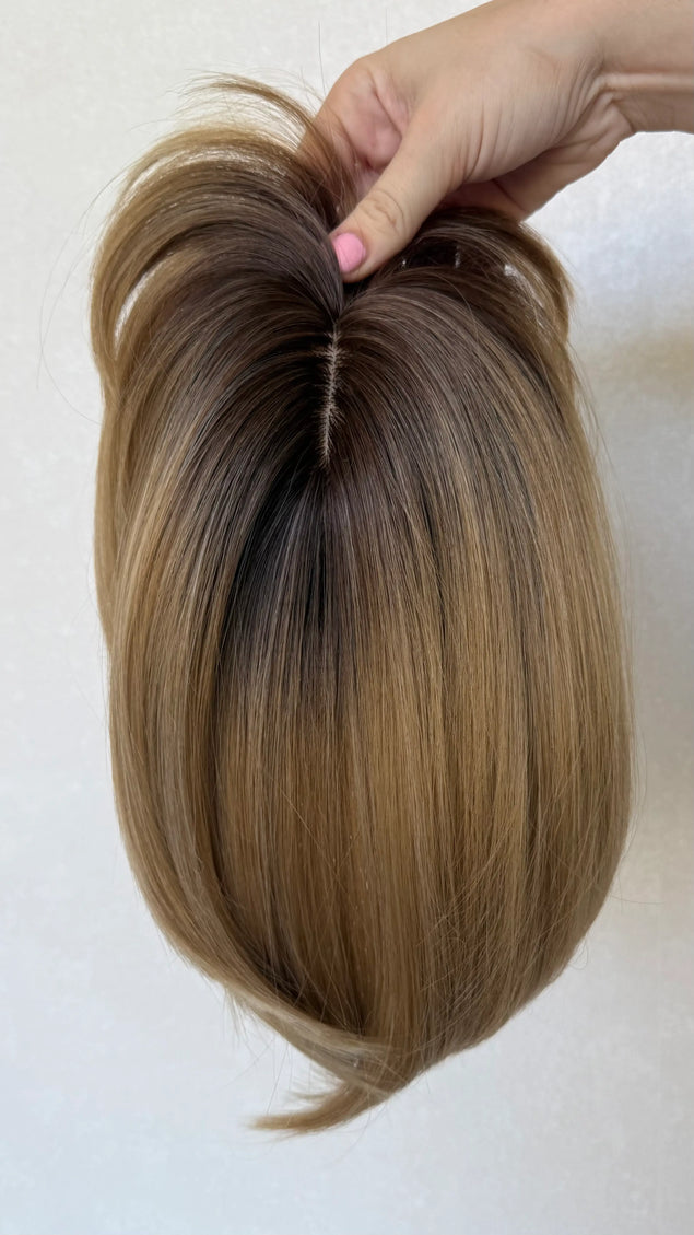 synthetic topper top view, showing hairline and part, dark root
