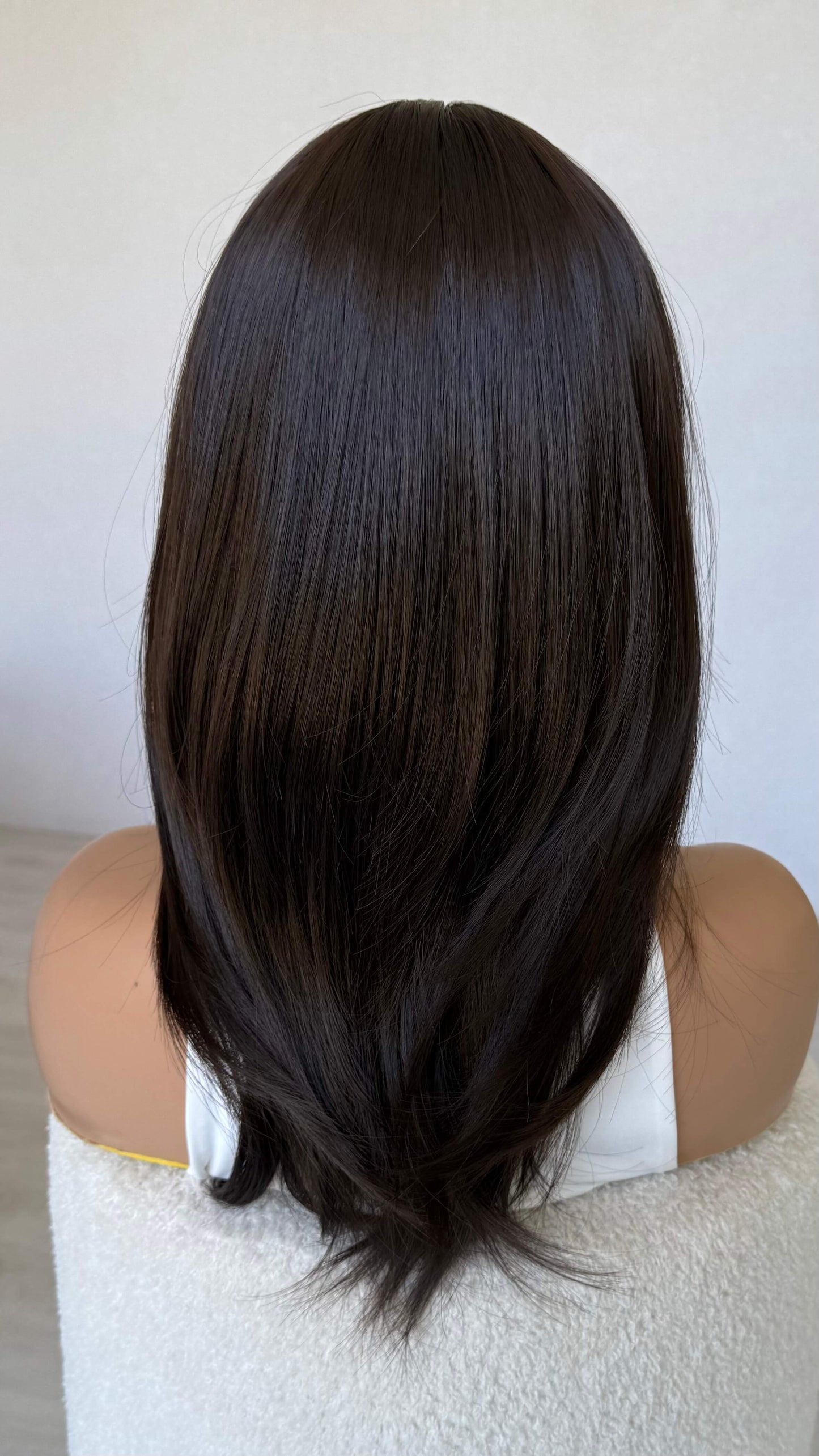 layered brunette synthetic hair wig from back view, showing layered hair, middle part. australia synthetic wigs, high quality.