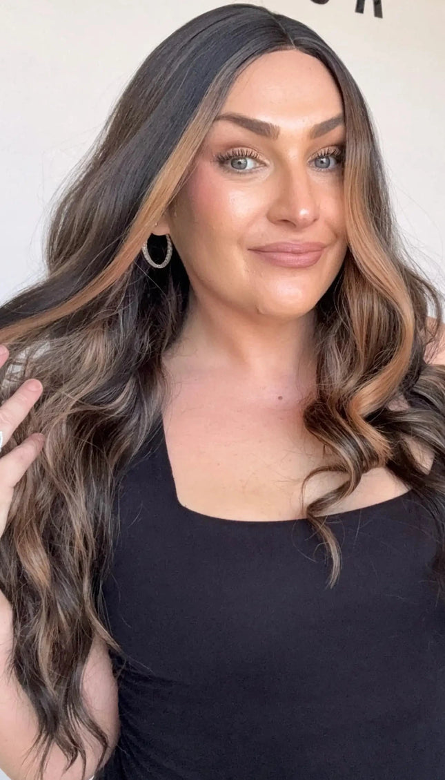 dark brunette wavy synthetic, middle part with face framing highlights.