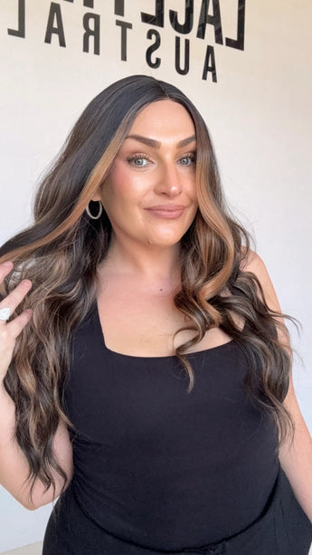 dark brunette wavy synthetic, middle part with face framing highlights.