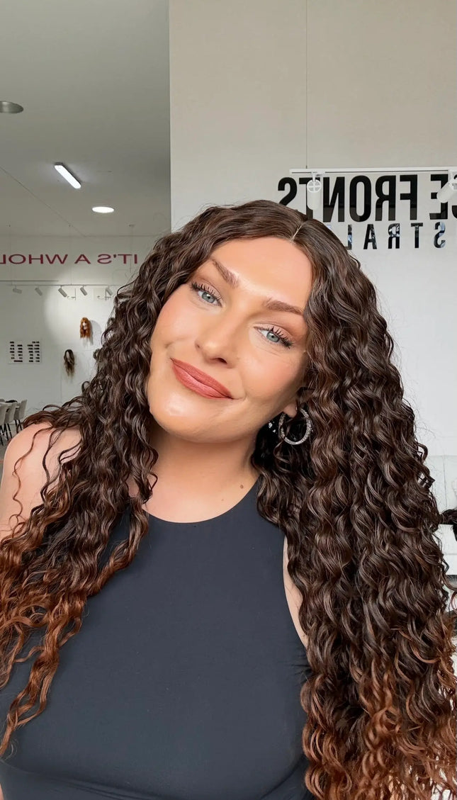 warm brunette ombre with chesnut ends, glueless wig cap for easy daily wear. middle part with long curly hair.