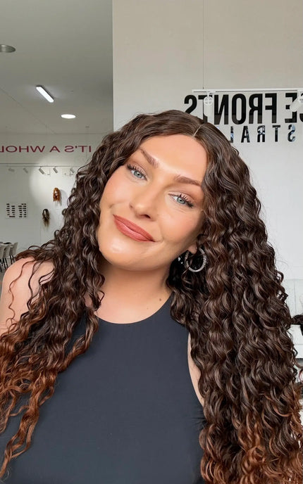warm brunette ombre with chesnut ends, glueless wig cap for easy daily wear. middle part with long curly hair.