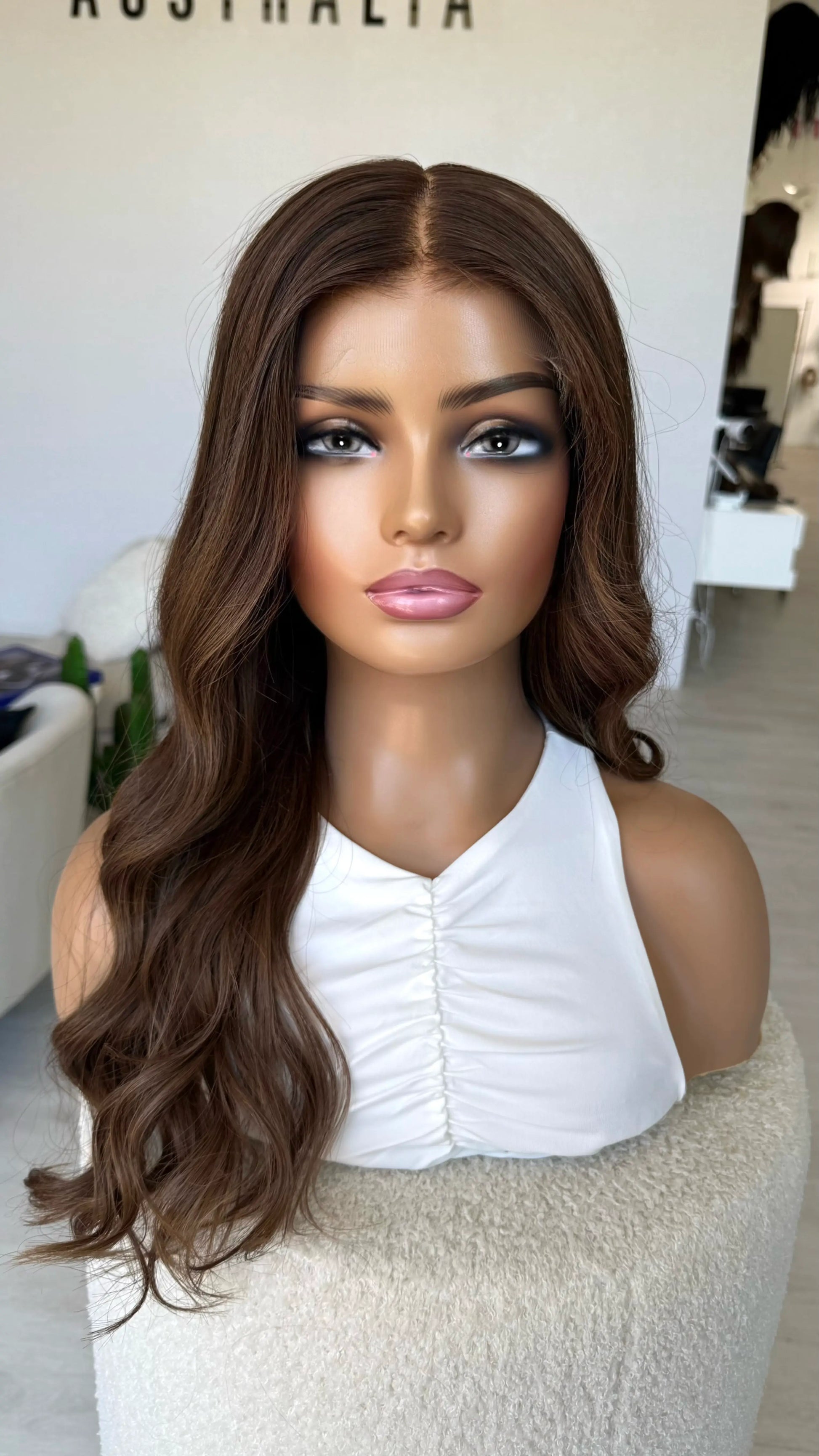 warm toned dark brunette 24 inches, wavy hair, middle part. medical lace front wig.
