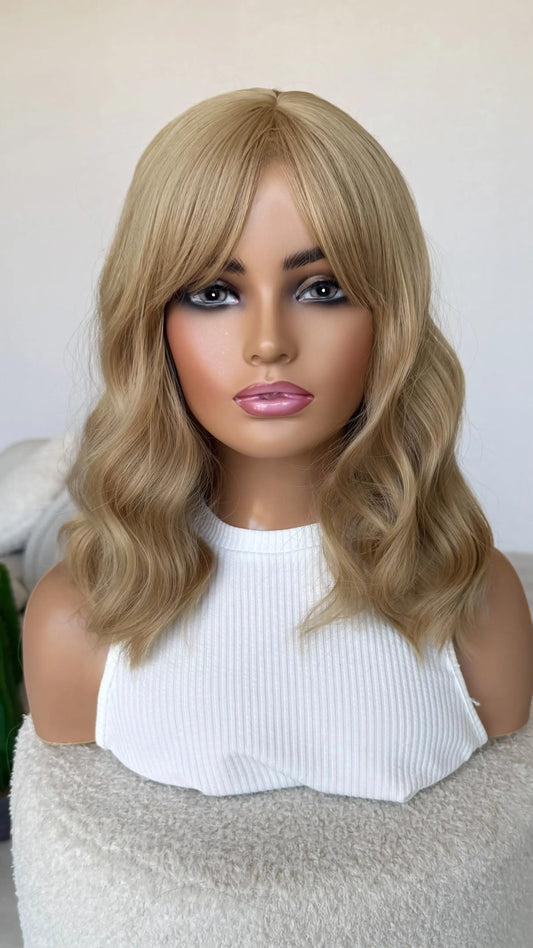 wavy blonde with longer fringe, glueless heat safe synthetic wig australia, honey blonde, middle part.