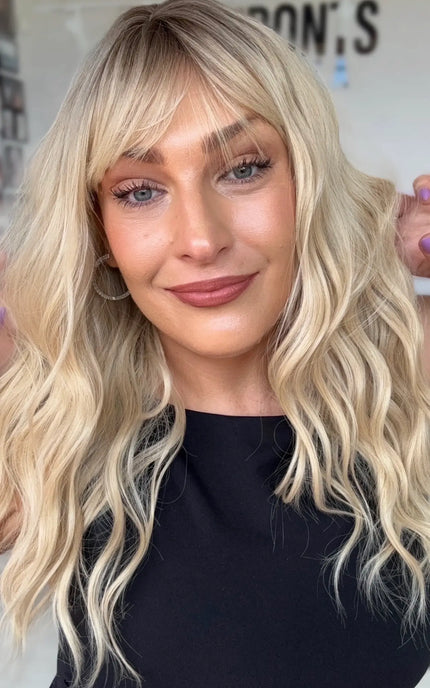 wavy blonde hair wig with middle part and soft wispy fringe, wavy medium length hair.