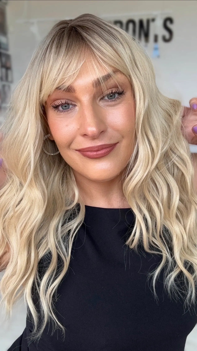 wavy blonde hair wig with middle part and soft wispy fringe, wavy medium length hair.
