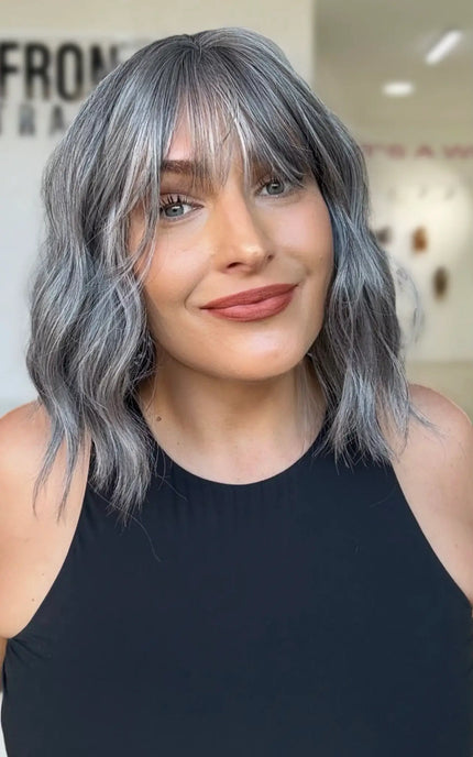 wavy ash grey hair with a middle part and soft fringe, sitting at collarbone length this is a perfect wavy bob for everyday wear
