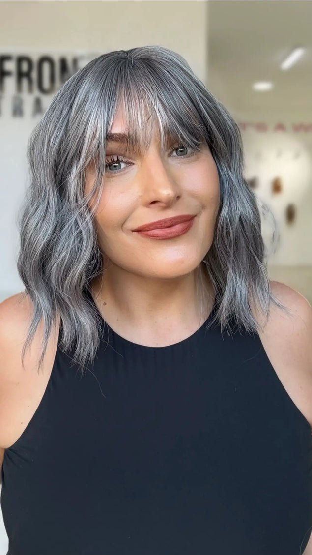 wavy ash grey hair with a middle part and soft fringe, sitting at collarbone length this is a perfect wavy bob for everyday wear