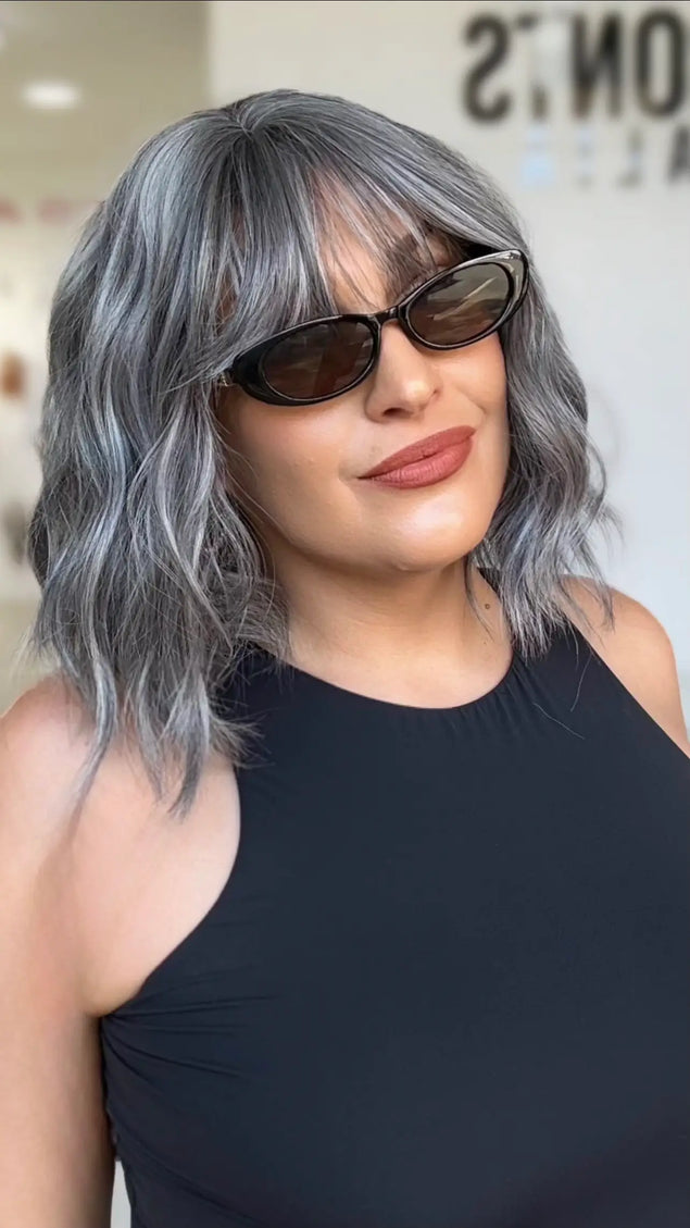 wavy ash grey bob length hair with middle part and soft wispy fringe, sitting at collarbone length.