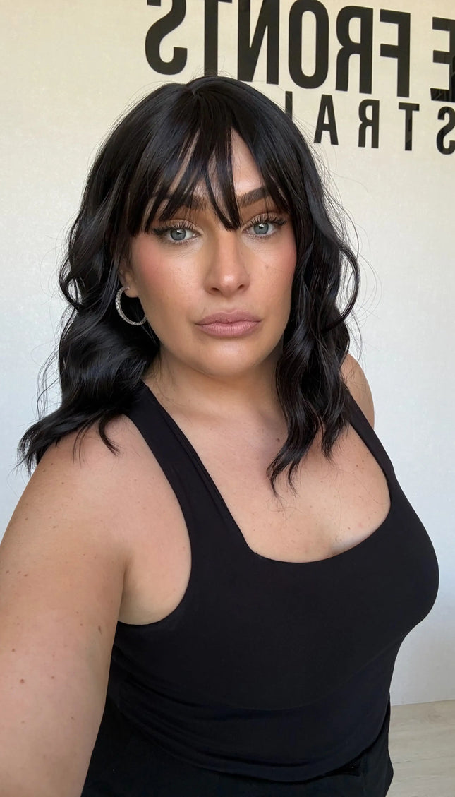 wavy black hair synthetic wig, middle part with wispy ends.