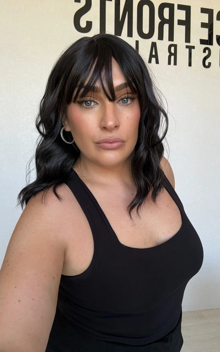 wavy black hair synthetic toppers, middle part with wispy ends.