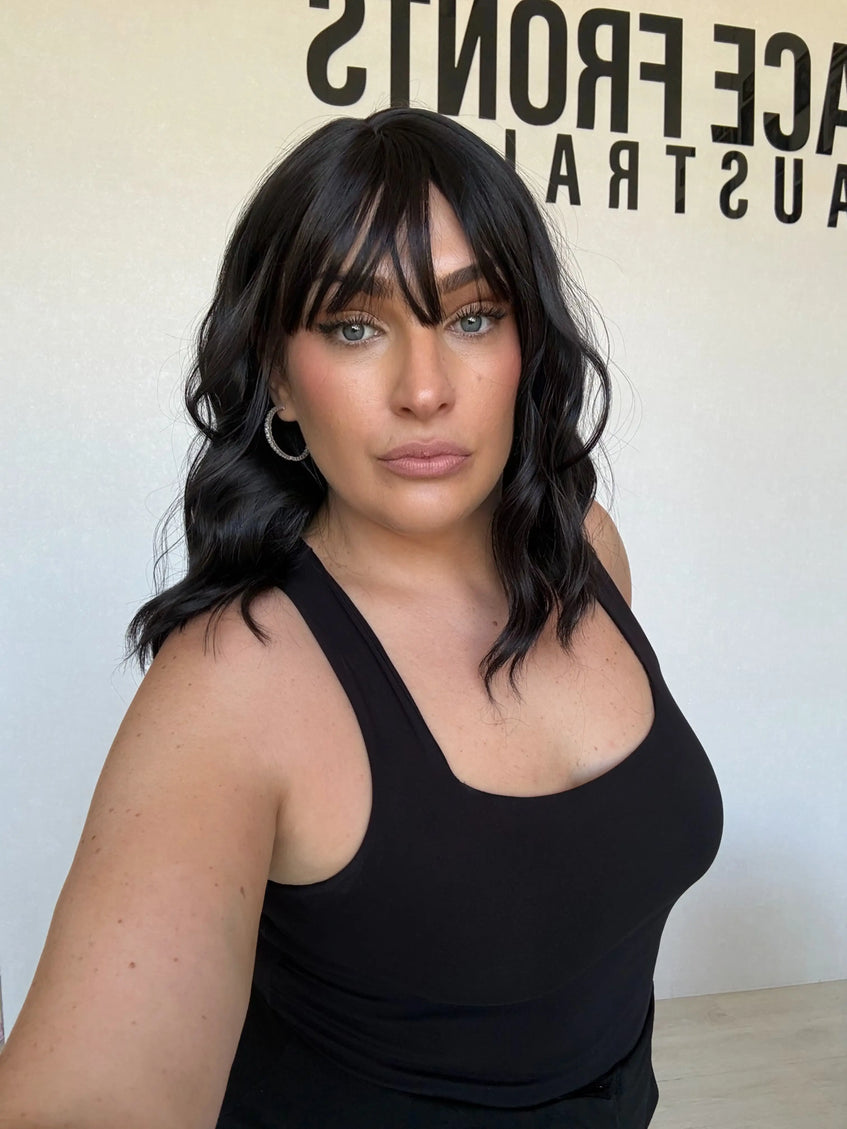 wavy black hair synthetic toppers, middle part with wispy ends.