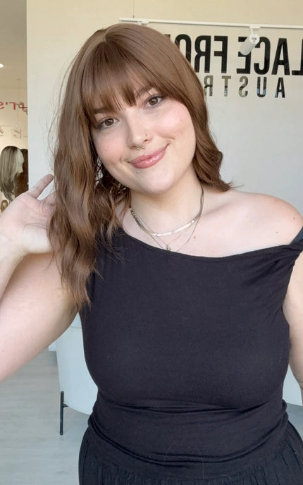 glueless synthetic wig australia, wavy brown hair, long bob with middle part and fringe.