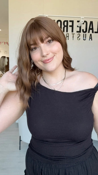 glueless synthetic wig australia, wavy brown hair, long bob with middle part and fringe.