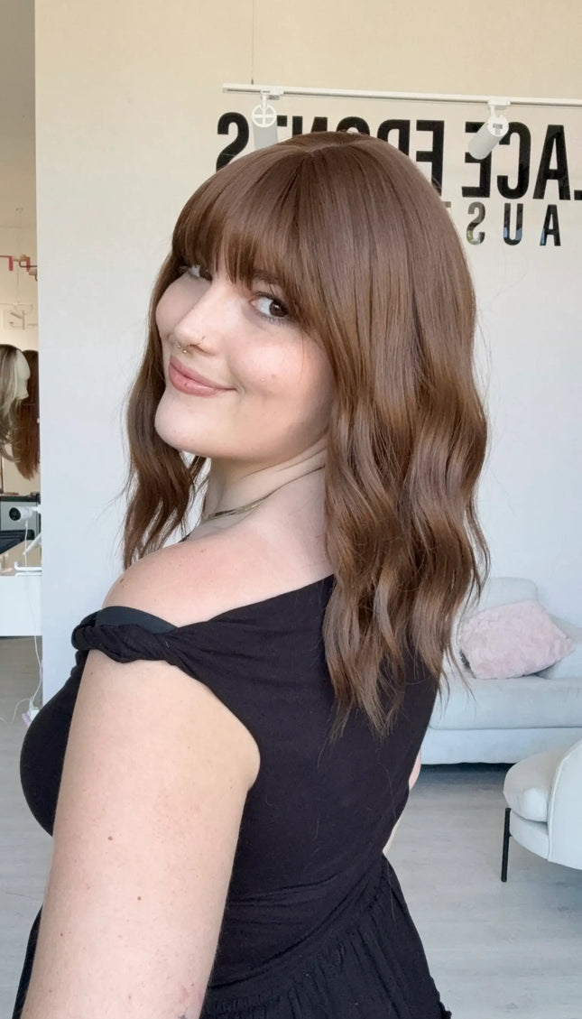 heat safe synthetic wig, brunette wavy hair with middle part and fringe.