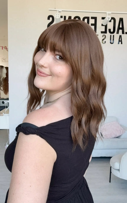 heat safe synthetic wig, brunette wavy hair with middle part and fringe.