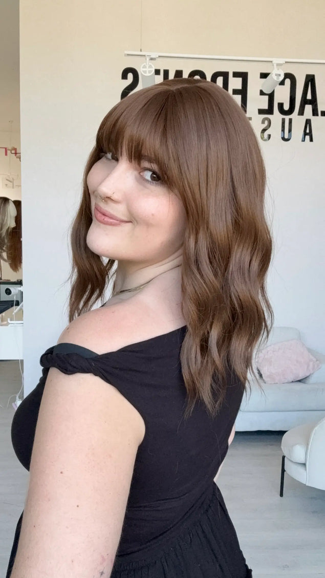 heat safe synthetic wig, brunette wavy hair with middle part and fringe.