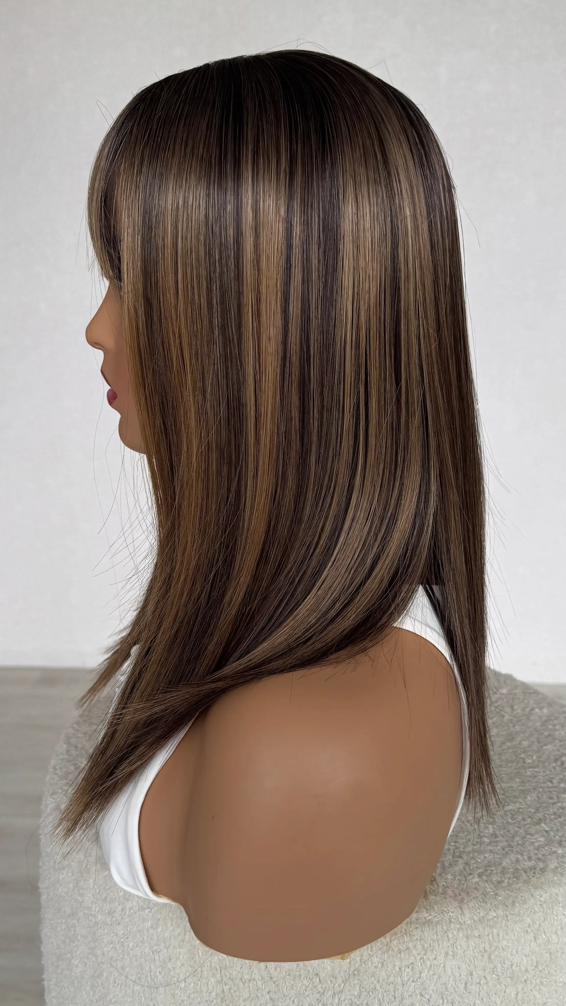 side view showing highlights through hair, long bob length